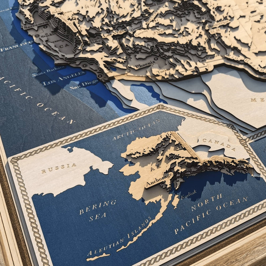 Contour map of Alaska, featuring Anchorage and neighboring Canada and Russia. It is a wooden map situated within a larger map of the whole United States