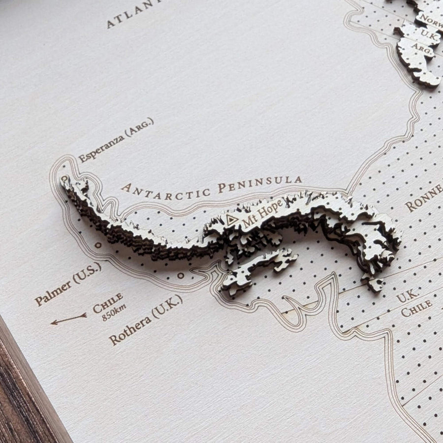 3D wooden map of the Antarctic Peninsula on a topographic map background