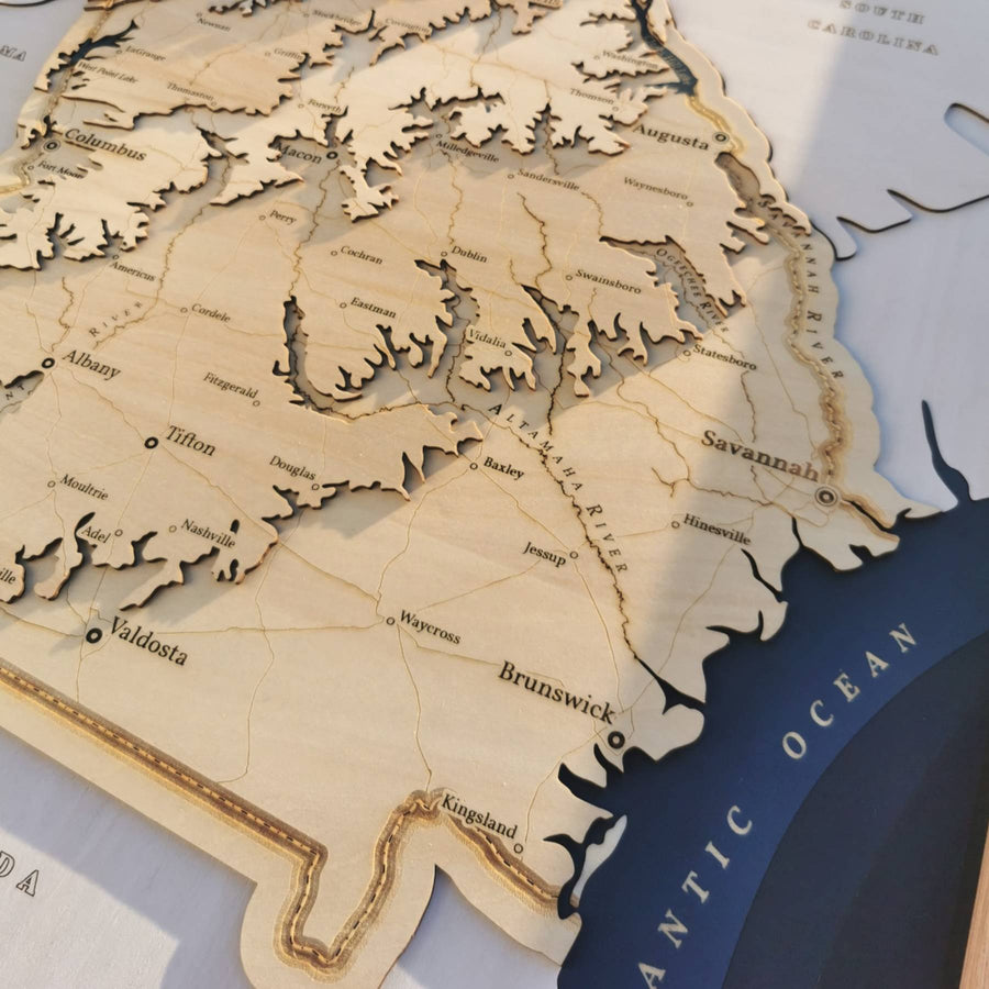 the altamaha river of georgia flowing into the atlantic as shown on a carved wooden map