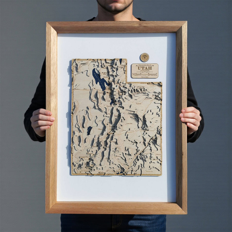 Wooden contour map of Utah held up