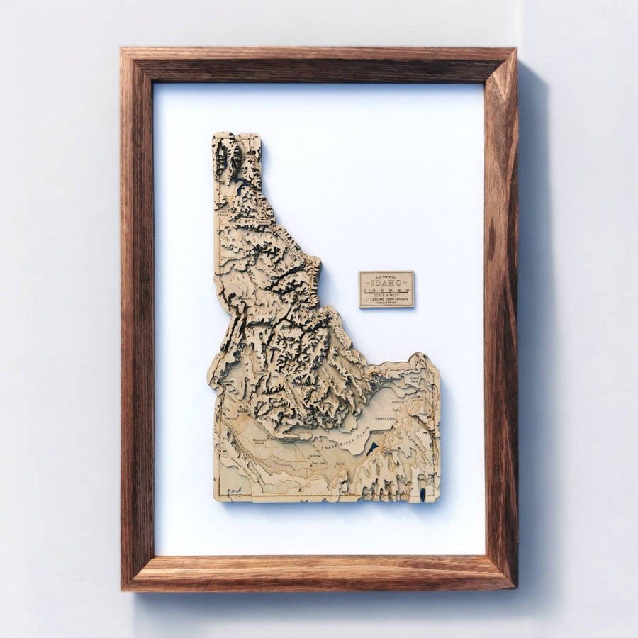 3D carved map of Idaho state with a wooden frame and clean white background