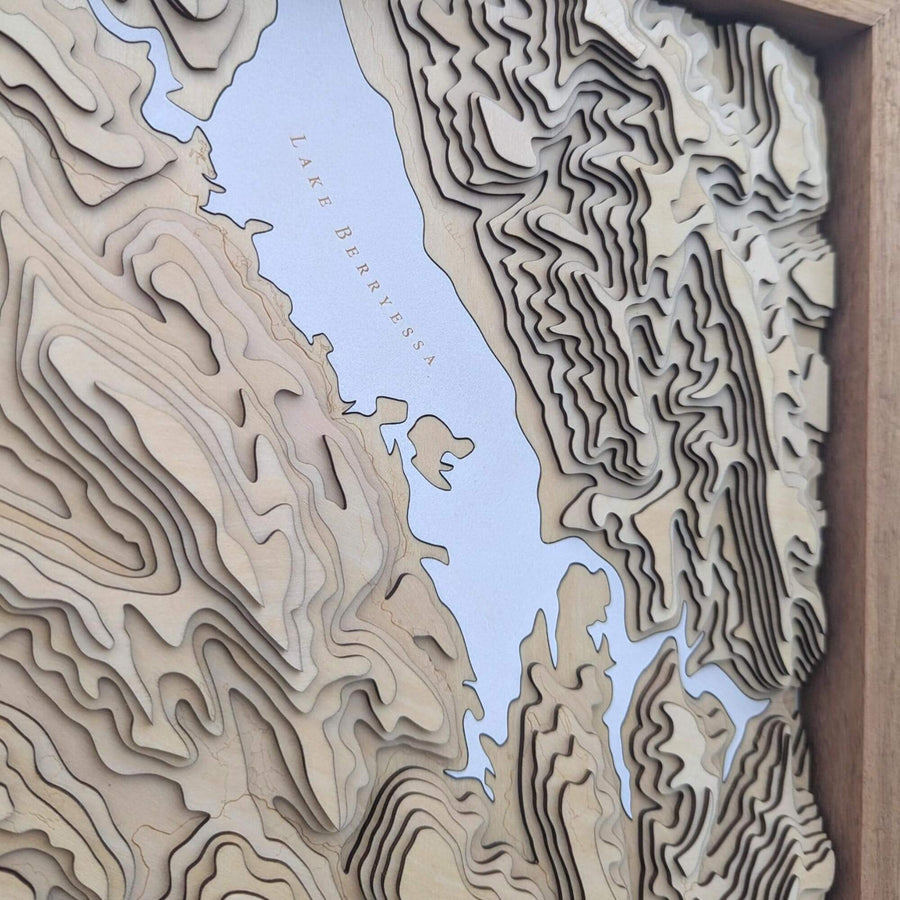 Topographic map with layered relief design on a wooden frame