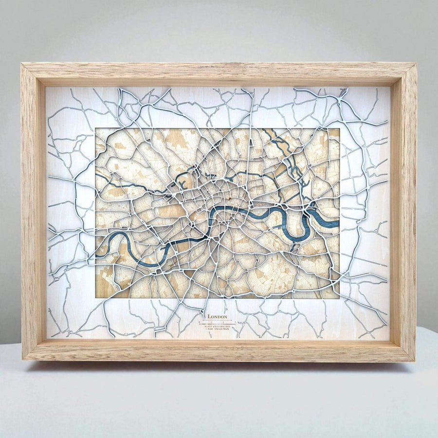 Framed map of London with a light wood frame on a gray background