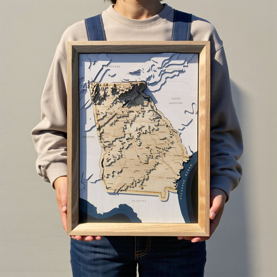 3d wooden map of the US state of Georgia held by a man