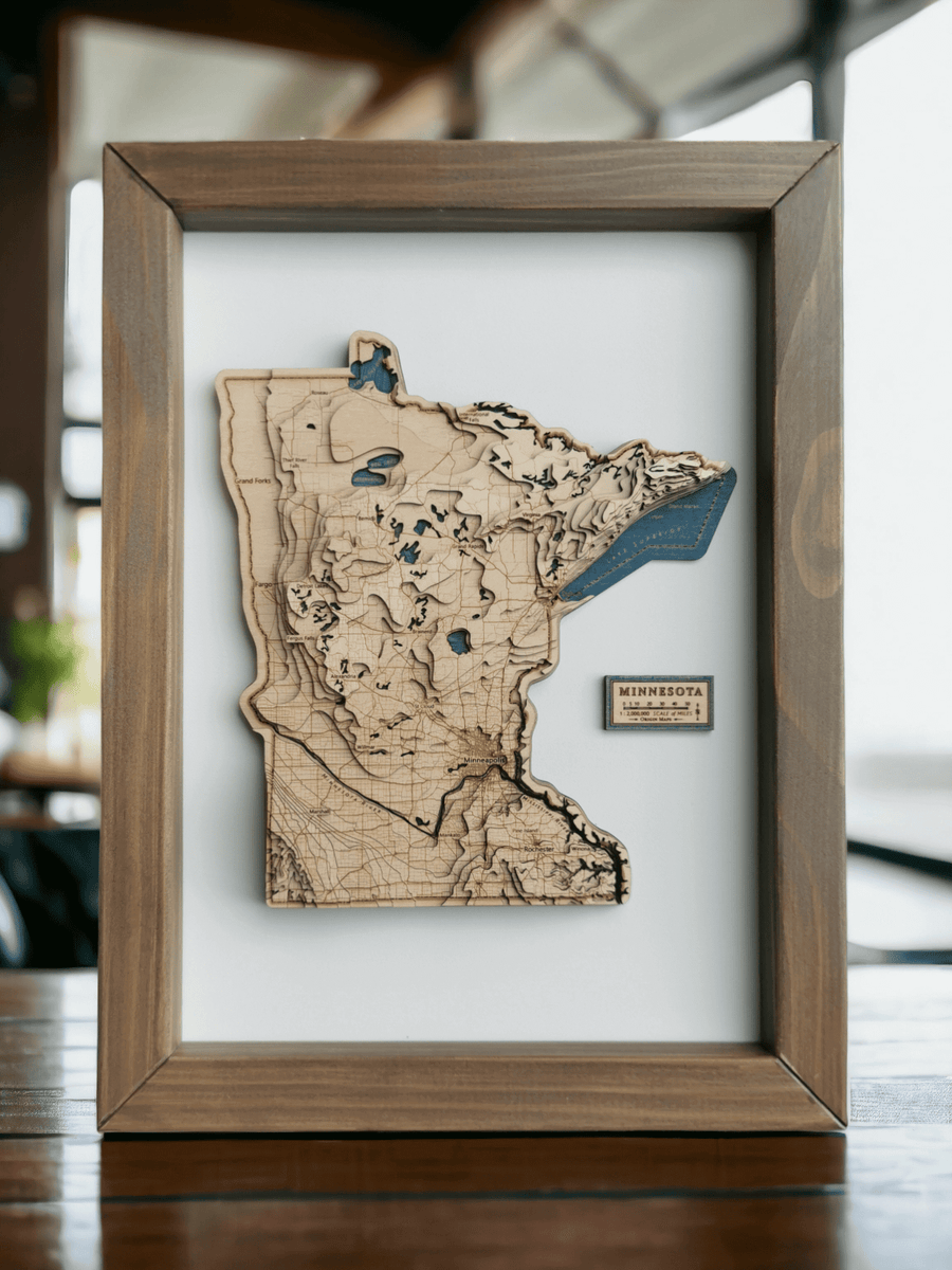 Minnesota State USA wooden topographic contour map sitting on a bench in a brown frame