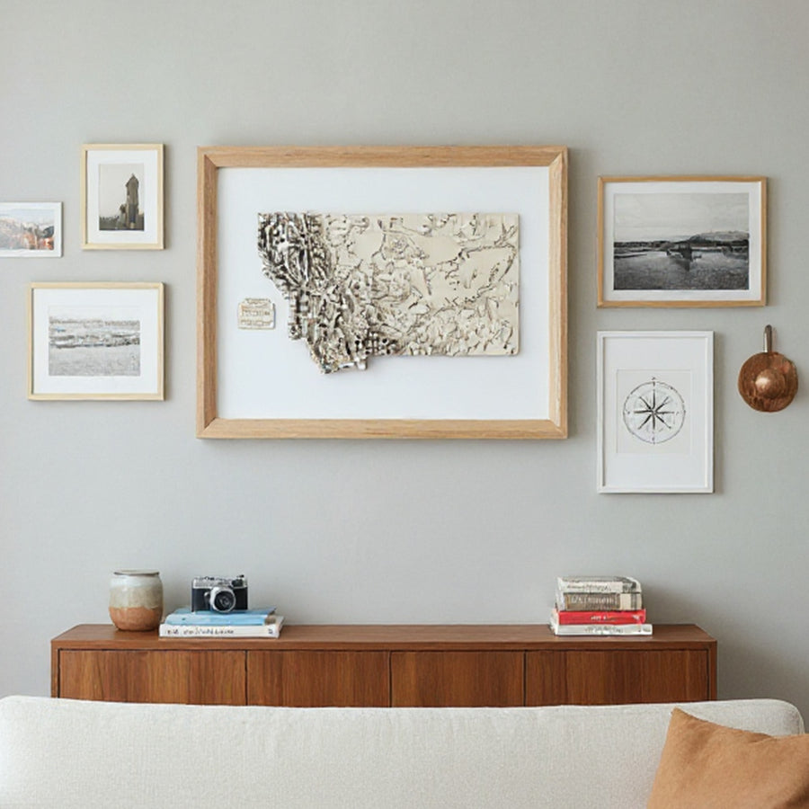 Framed map of Montana on a wall with other pictures