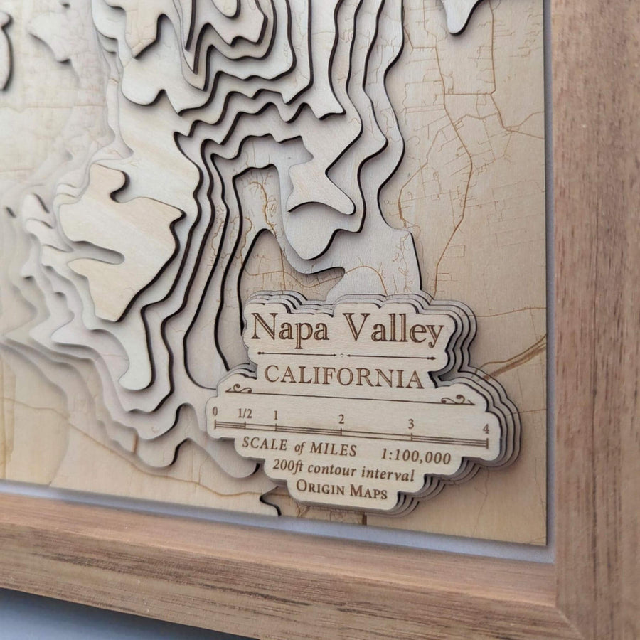Wooden topographic map of Napa Valley, California with scale and origin maps branding.