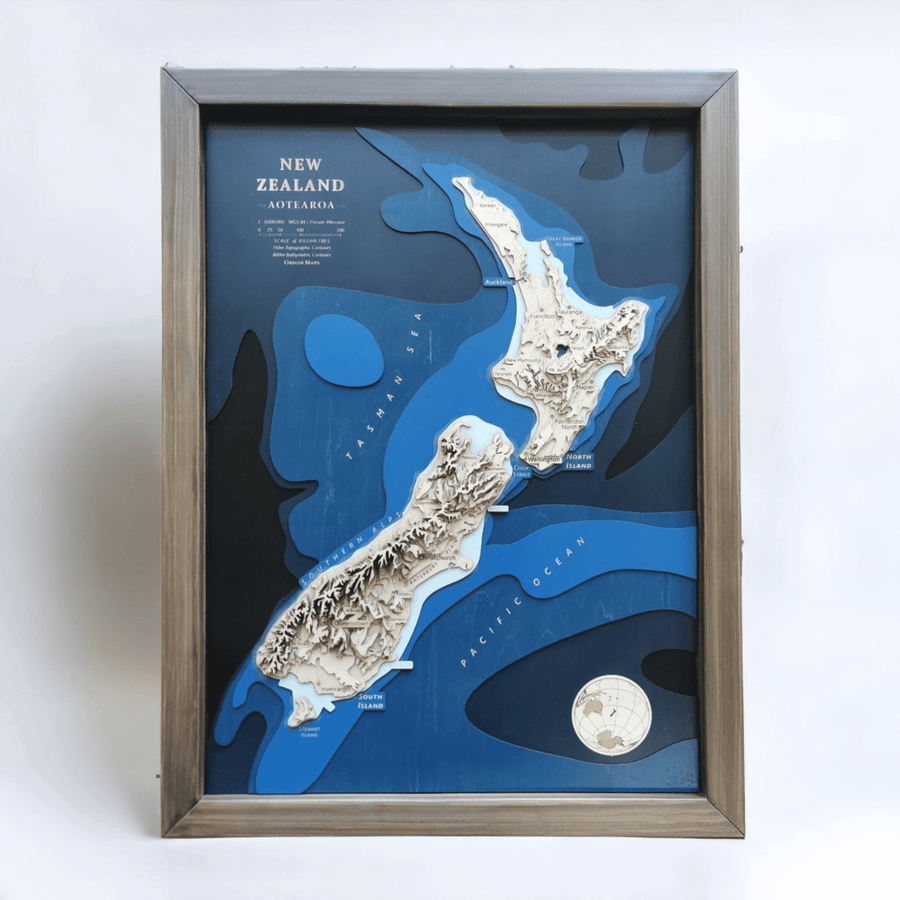 Product image of a framed wooden topographic map of new zealand that is meant for gifting