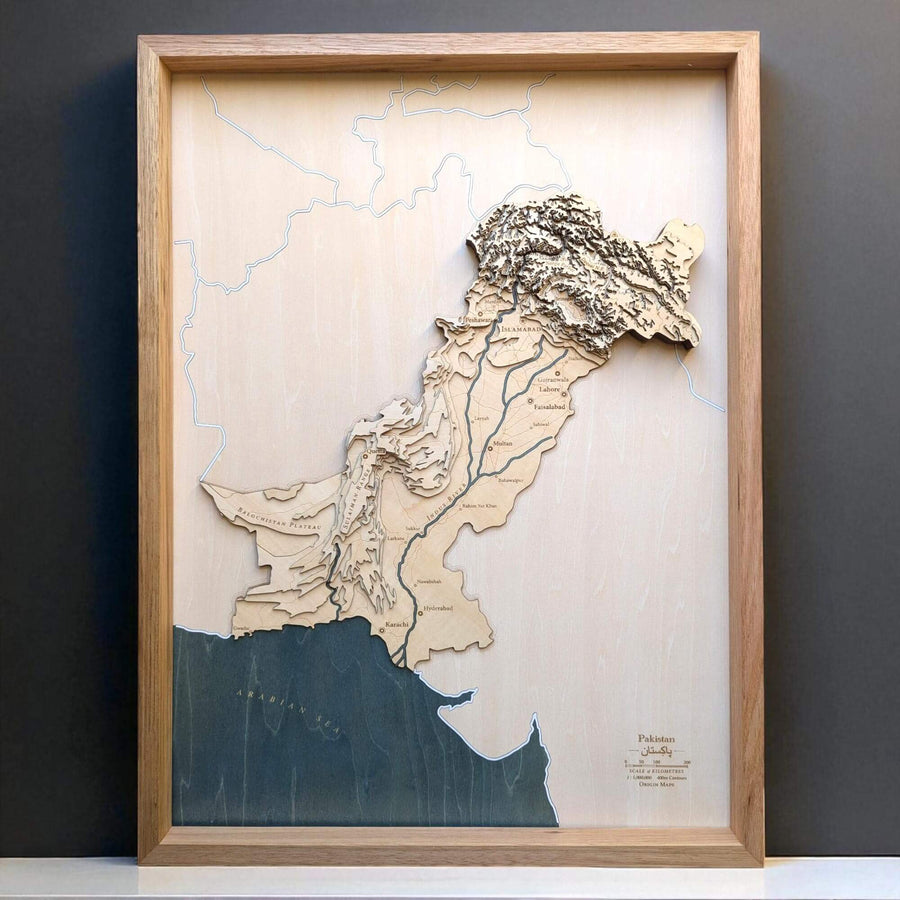 Wooden map of Pakistan with a wooden frame on a dark background