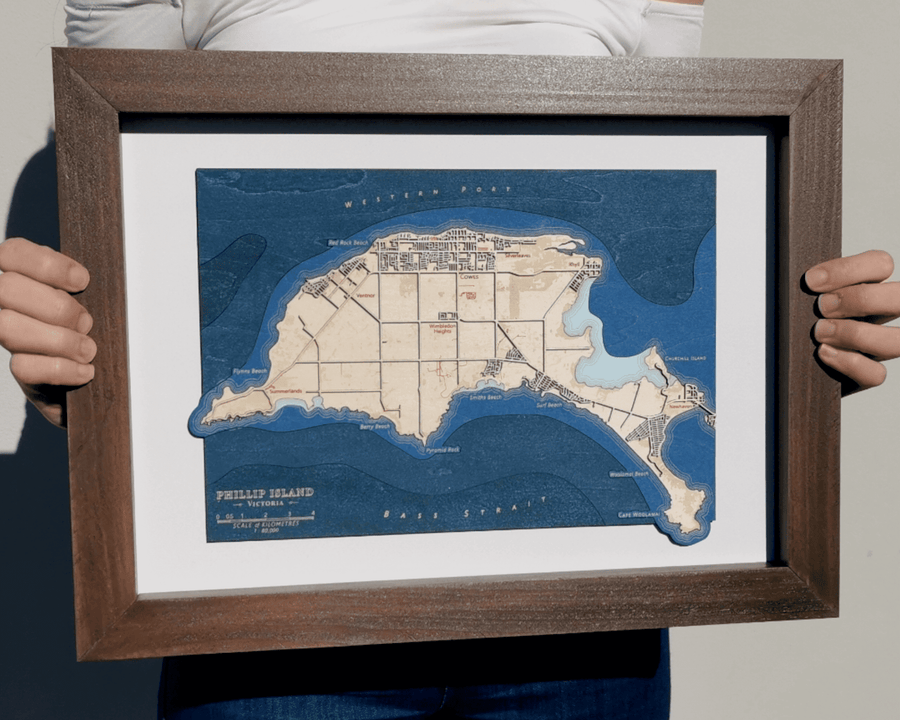 Phillip Island Victoria Australia Wooden Laser Cut Map Art, held by a girl