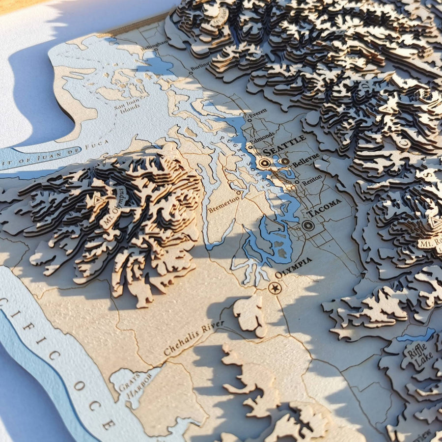 Seattle and tacoma and olympia of washington state as shown on a carved 3d map